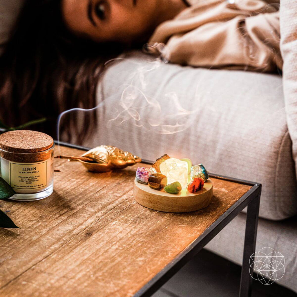 Candle and decorative items on a coffee table with a blurred person in the background