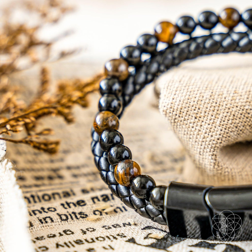 Close-up of a beaded bracelet on a textured surface with text