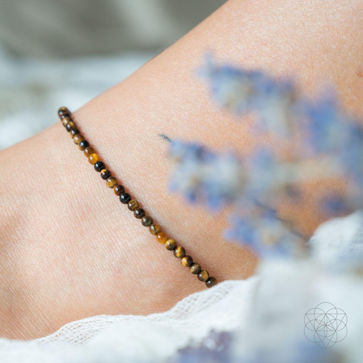 Close-up of a beaded bracelet on a wrist with a blurred background