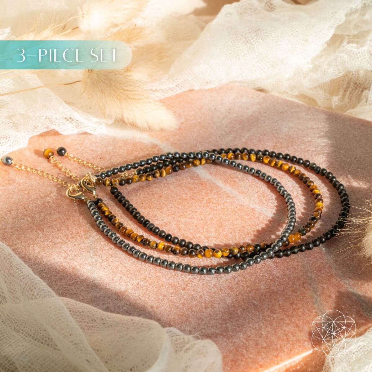 Three beaded necklaces on a hand with a soft background