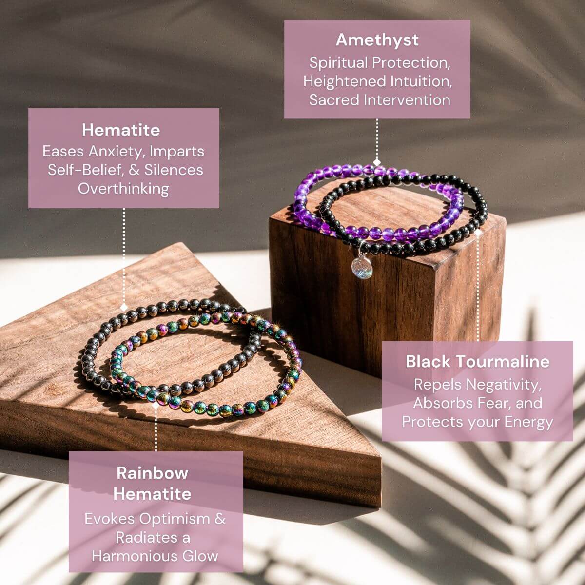 Three beaded bracelets on a wooden stand with descriptive text about each stone's properties.