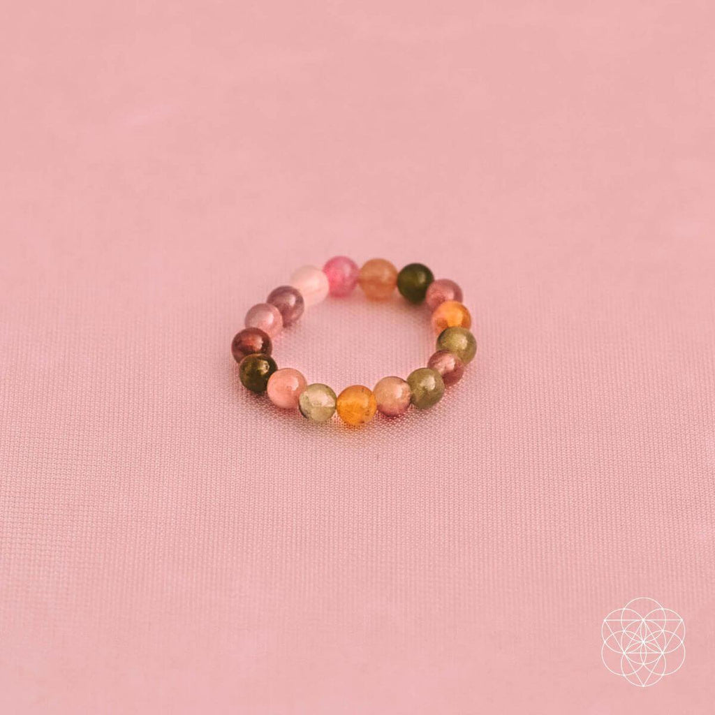 Multicolored beaded bracelet on a pink background